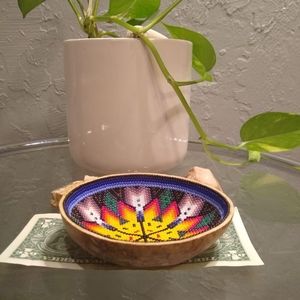 This is a wooden bowl with beads